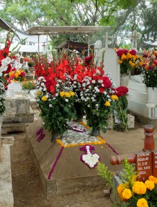 Flowers decorate the sand structure on this view of a grave site at San Antonín
