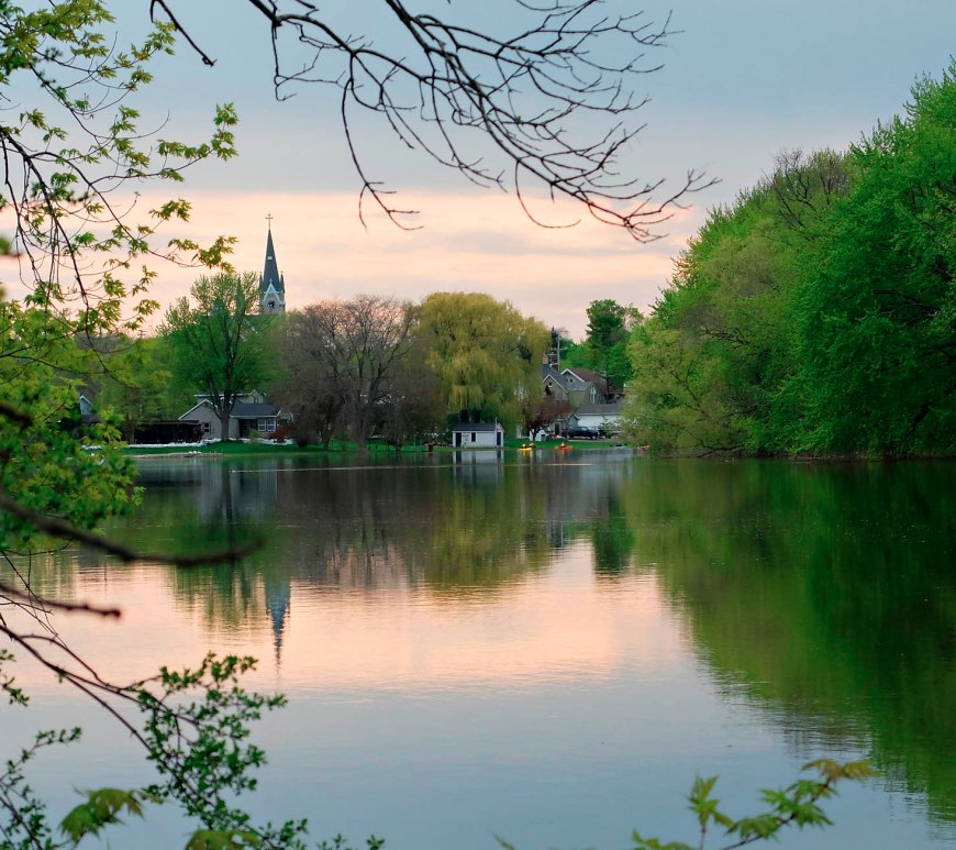 Along a very calm Rock River in Fort Atkinson looking east with the reflection of the sunset in the river.