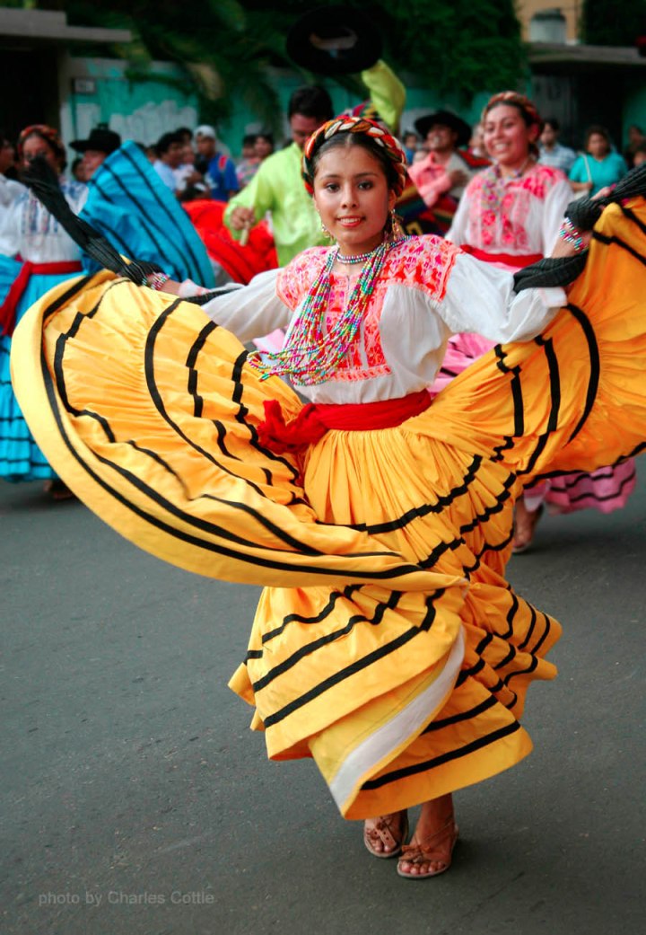 A Dancer from Ejutla de Crespo, Oaxaca - Yellow skirt billowed - She is facing the camera.