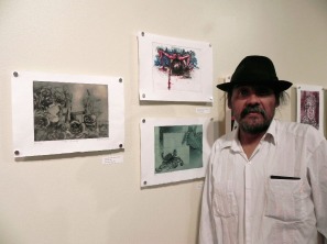 Maestro standing in front of artwork in a gallery.