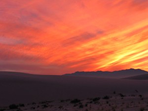 Vibrant sunset with dunes in foreground