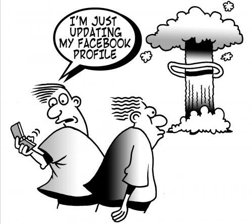 Cartoon: Fellow is updating his facebook account while nuclear warhead explodes.