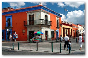 Street scene in the city of Oaxaca. Brightly colored buildings from the 18th century.